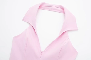Detail of pink halter neck shirt featuring sharp collar and invisible front zipper