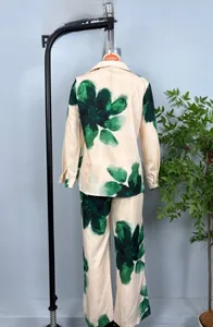 Detail view of the back of a beige floral long-sleeve shirt and matching trouser set