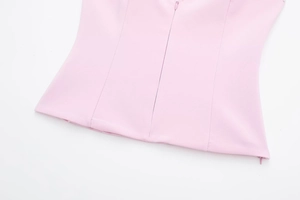 Close-up detail of smooth pink fabric featuring a high-quality invisible back zipper