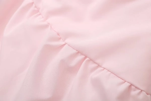 Detail shot of pink slim-fit tube top showing fine ruched fabric and precision stitching