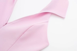 Close-up of light pink top featuring a crisp collar design and hidden side zipper detail