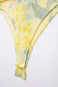 Close-up of yellow mesh bodysuit with floral print and high-quality seam details