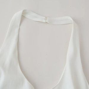 White halter neck dress featuring a back dual-button closure and tiered design details