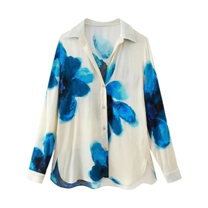 Detailed flat lay of silk-like long sleeve shirt with blue abstract floral patterns