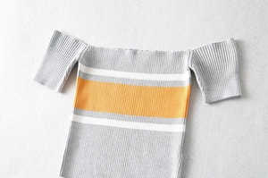 Detail shot of the vertical ribbed texture and striped knit pattern on the crop top