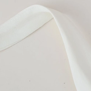 White summer layered dress with matching belt showing detail of woven shoulder strap