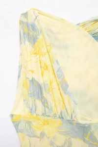Detail of yellow and blue floral print mesh bodysuit with ruching and layered tulle texture