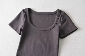 Detailed close-up of dark grey U-neck crop top with fine double-needle stitching quality