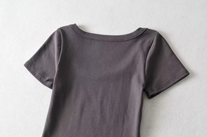 Close-up of charcoal grey short sleeve top showing round neckline and fine stitching