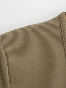 Detail of olive green ribbed knit top showing high-quality stitching and fabric texture