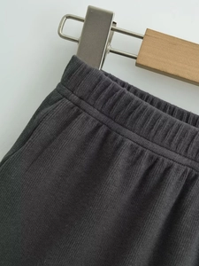 Detail of dark grey ribbed knit shorts with an elastic waistband and soft fabric texture