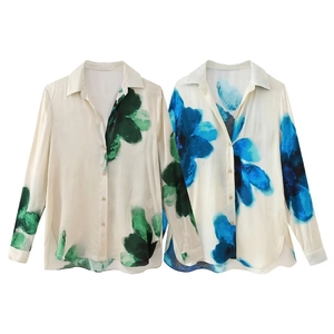 Detail of vibrant watercolor floral print shirts with classic lapels and button closure