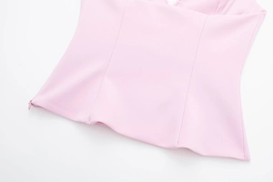 Close-up of pink halter top showing seam details and side invisible zipper closure