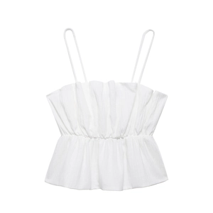 Close-up detail of white camisole top featuring pleated texture and thin shoulder straps