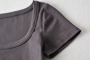 Close-up of double-needle stitching on charcoal grey cropped T-shirt sleeve and collar
