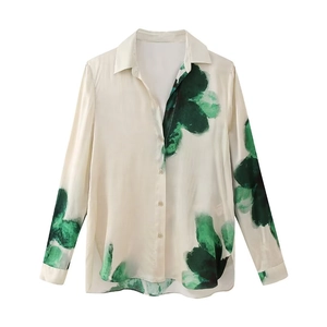 Close-up of floral print satin long sleeve shirt with side slits and smooth texture