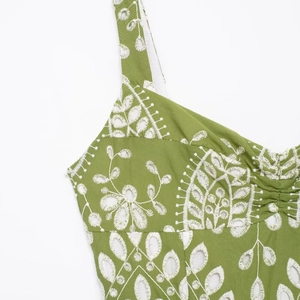 Green eyelet embroidery midi dress with delicate shoulder straps and ruffled chest detail