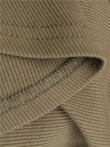 Macro shot of brown ribbed knit fabric with professional double-needle stitching detail