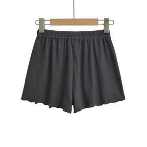 Detail of charcoal grey ribbed shorts featuring elastic waist and lettuce edge hem