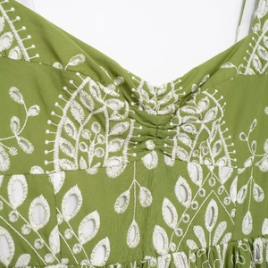 Green eyelet summer midi dress with white floral embroidery and ruched chest detail
