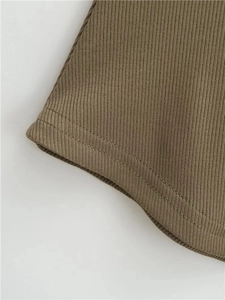 Detail of olive green ribbed knit fabric showing neat double-needle hem stitching