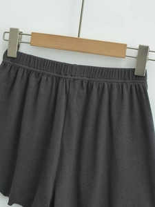 Detail of charcoal grey ribbed knit shorts featuring a wide elastic waistband for comfort