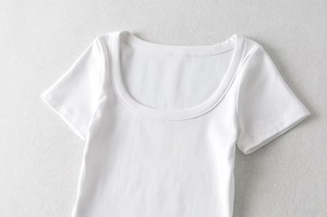 Detailed close-up of a white short-sleeve T-shirt with a square neckline and soft fabric