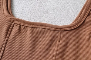 Close-up of caramel brown ribbed knit top featuring a square neckline and fine stitching