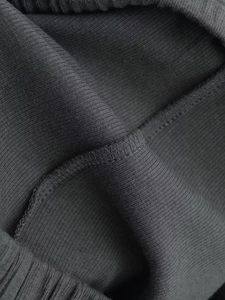 Detail shot of overlock stitching and rib-knit texture on these charcoal grey shorts