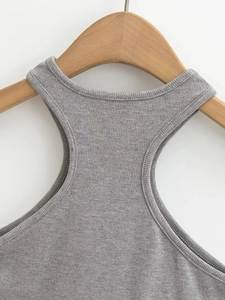 Close-up of grey ribbed knit tank top showing high neckline and racerback strap details