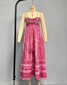 Detail of pink bohemian maxi dress showing red tribal prints and tassel tie front