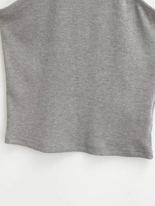 Detail of the grey ribbed knit fabric and neat double-needle hem on a slim-fit crop top