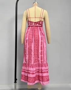 Detail of pink bohemian maxi dress with ethnic geometric patterns and ruffle hem detail