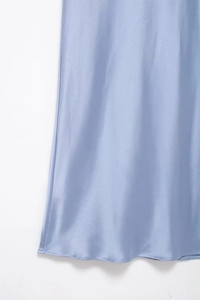 Close-up of light blue satin fabric showing silky texture and elegant drape detail