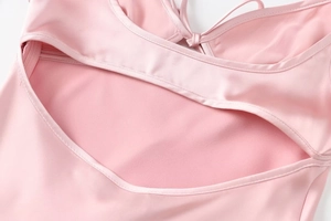 Detail of pink satin dress featuring cut-out design and adjustable back straps