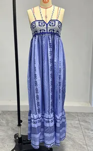 Detail of blue bohemian dress featuring white crochet lace stitching on the neckline