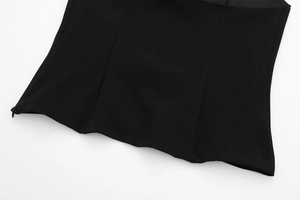 Detail of black halter top featuring invisible side zipper and three-panel construction