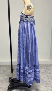 Detailed macro view of the crochet patchwork and blue geometric patterns on the dress