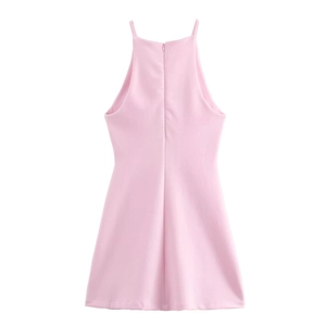 Detail of invisible back zipper on a light pink halter dress with soft fabric texture