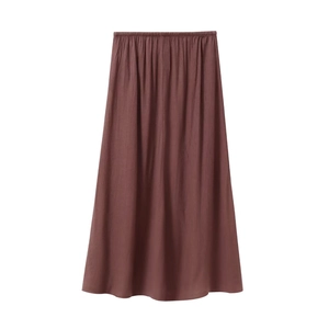 Detail of dark brown pleated maxi skirt showing vertical texture and elastic waistband