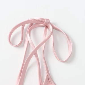 Elegant pink satin dress featuring adjustable shoulder straps with a delicate knot design