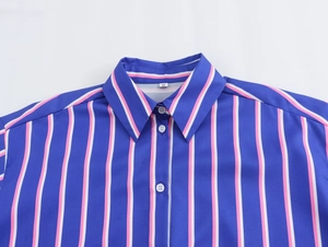 Close-up of the classic collar and white buttons on a blue striped women's shirt