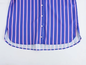 Detail of blue striped shirt showing white buttons and rounded high-low hemline
