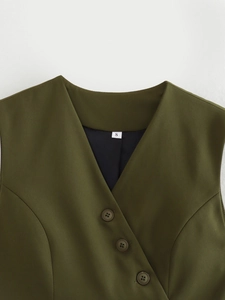 Detail of olive green asymmetric vest showing V-neck, resin buttons, and size S label