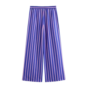 Detailed view of high-waisted wide leg trousers with colorful vertical stripes and elastic waist