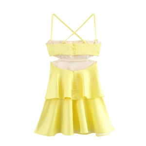 Yellow satin strapless dress with cross back and layered ruffle hem in minimalist style