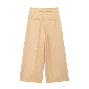 Detail view of khaki high-waisted wide-leg trousers featuring rear welt pockets and crisp pleats