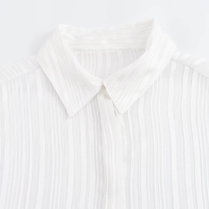 Women's minimalist white long-sleeve shirt with fine vertical texture and classic collar