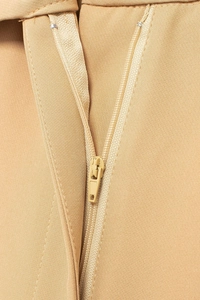 Close-up of high-quality zipper and khaki woven fabric texture on wide leg pants