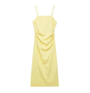 Detail of light yellow midi dress featuring fine double straps and side ruching detail